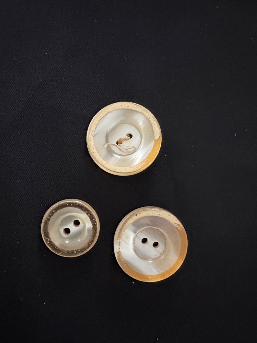 Three mother of Pearls buttons, trimmed and gold